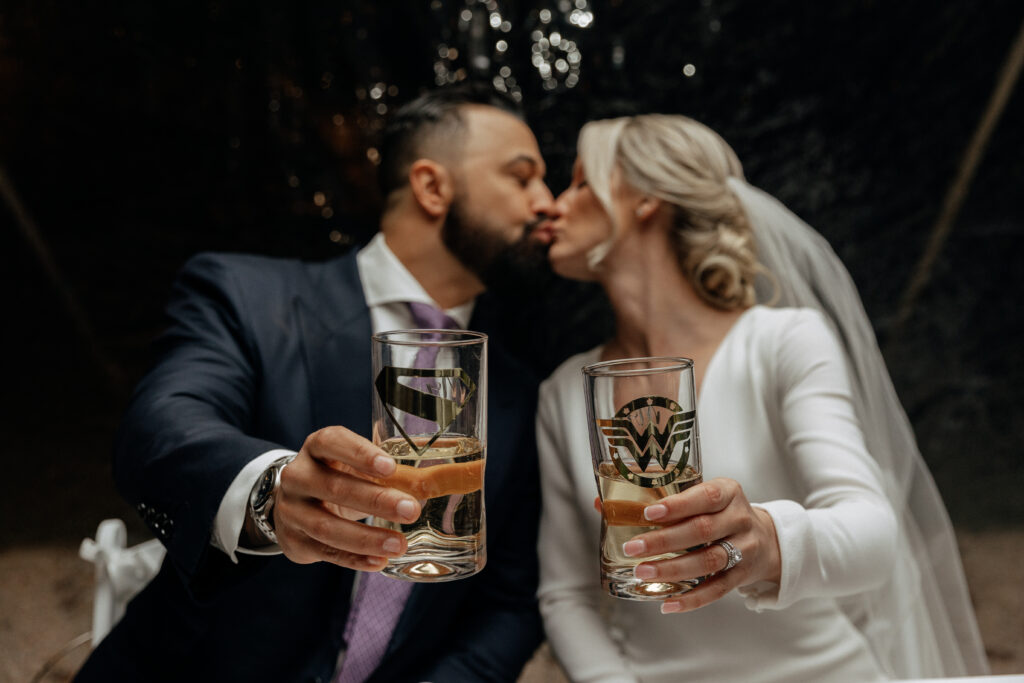 newlyweds with their superman and wonder woman cups